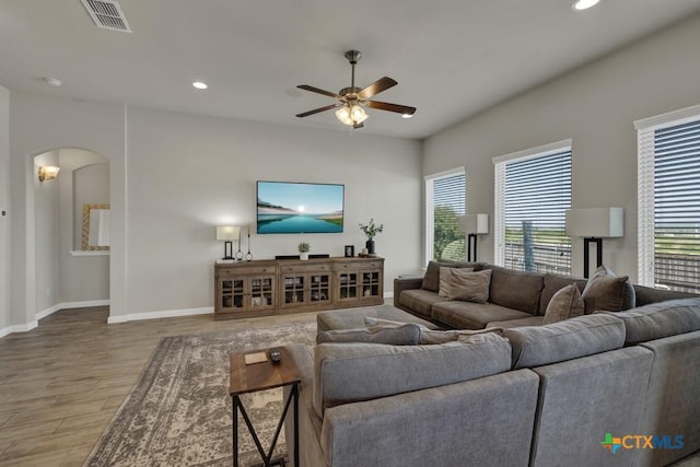 3214 Roan St, New Braunfels, TX 78130 - living room with wood finished floors, ceiling fan, arched walkways, and recessed lighting