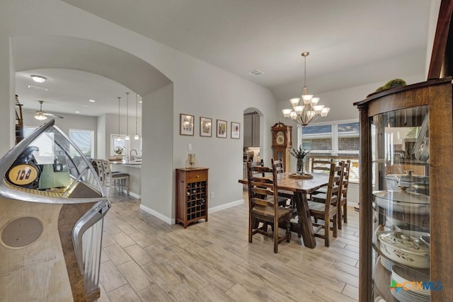 3214 Roan St, New Braunfels, TX 78130 - dining room featuring arched walkways, a chandelier, light wood-style flooring, and ceiling fan