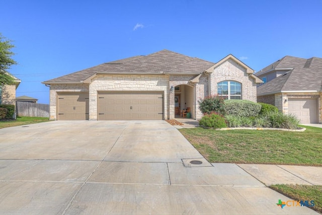 3214 Roan St, New Braunfels, TX 78130 - french country home with driveway, a garage, a front lawn, brick siding, and stone siding