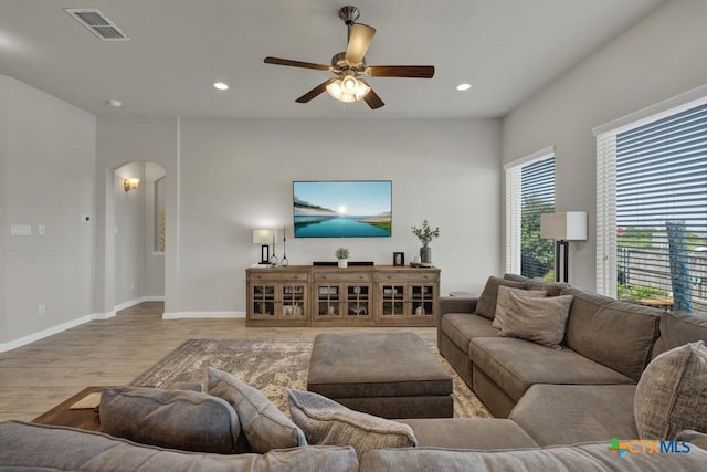 3214 Roan St, New Braunfels, TX 78130 - living room with arched walkways, wood finished floors, ceiling fan, and recessed lighting