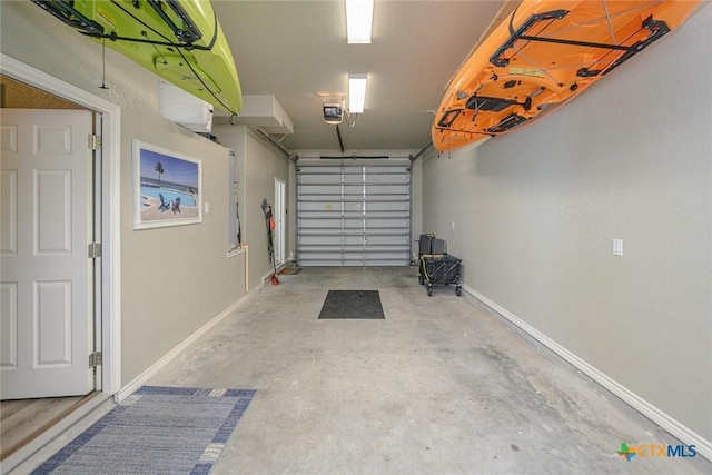 garage with baseboards and a garage door opener