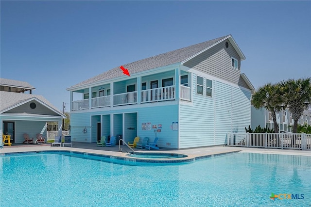 exterior space with a community hot tub, a patio area, and fence