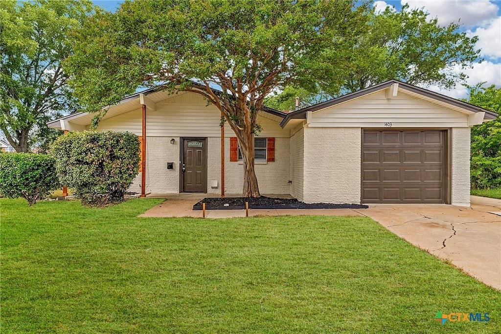 1403 Gardenia Ave, Killeen, TX 76543 - ranch-style home featuring driveway, a garage, a front lawn, and brick siding