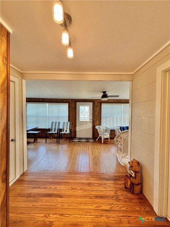 hallway with hardwood / wood-style flooring and ornamental molding