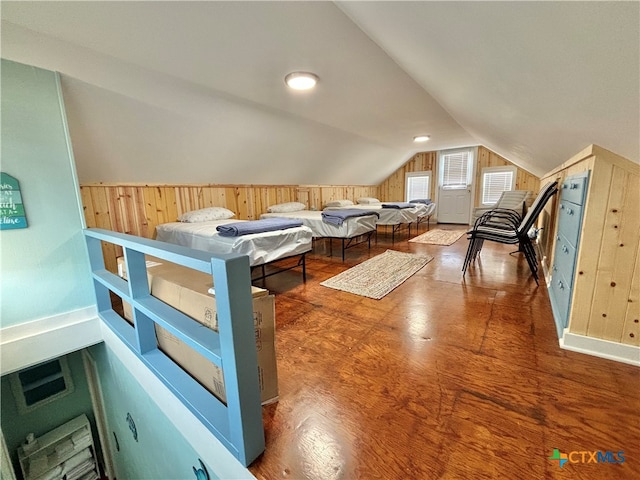 unfurnished bedroom featuring hardwood / wood-style floors and vaulted ceiling