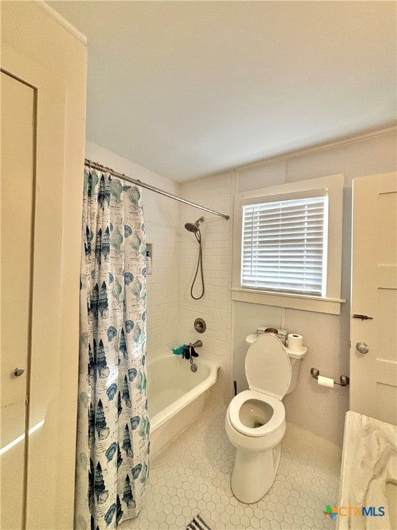 bathroom featuring toilet, tile patterned floors, and shower / bathtub combination with curtain