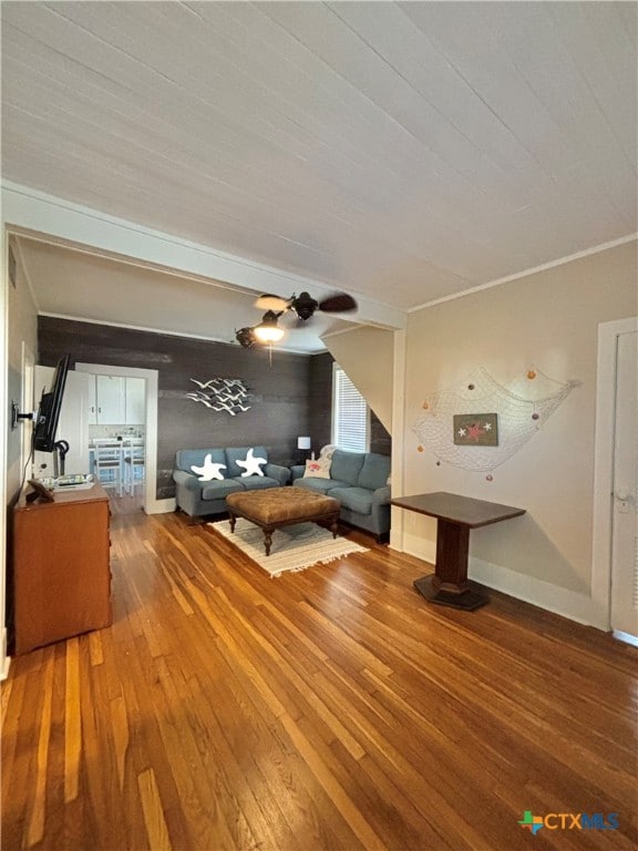 unfurnished living room with hardwood / wood-style flooring and crown molding