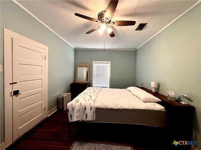 bedroom with ornamental molding, ceiling fan, and dark hardwood / wood-style floors