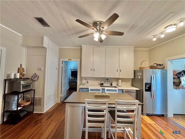 kitchen featuring wood-type flooring, decorative backsplash, stainless steel fridge with ice dispenser, ceiling fan, and white cabinetry