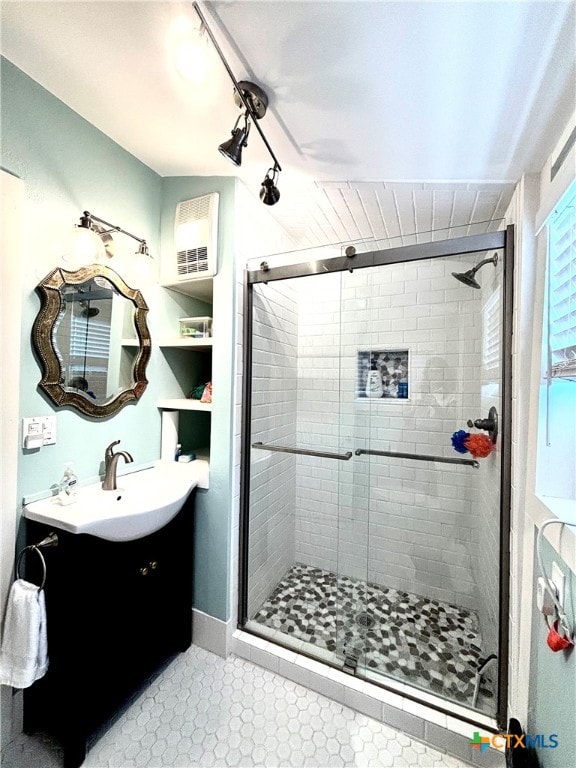 bathroom with walk in shower and vanity