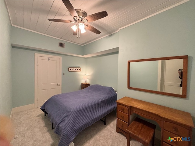 bedroom featuring light carpet, ceiling fan, crown molding, and wooden ceiling