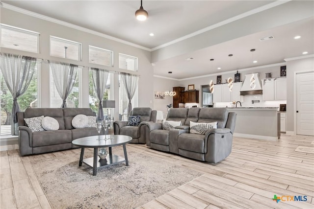 living area with recessed lighting, light wood-type flooring, and crown molding