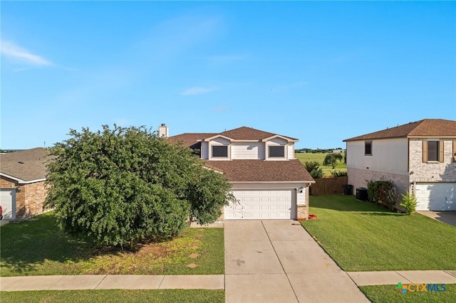 2604 Mikulec Dr, Killeen, TX 76542 - view of front of home with concrete driveway, an attached garage, a chimney, and brick siding