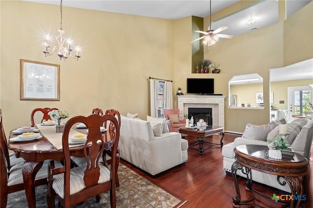 2604 Mikulec Dr, Killeen, TX 76542 - living area featuring dark wood-type flooring, a chandelier, ceiling fan, a high ceiling, and a tile fireplace