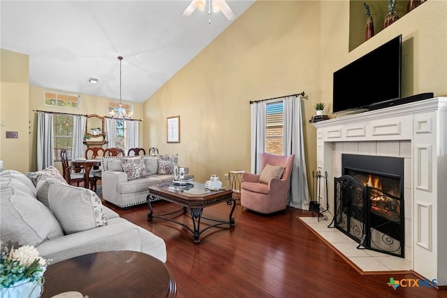 2604 Mikulec Dr, Killeen, TX 76542 - living room featuring high vaulted ceiling, wood finished floors, a tile fireplace, a chandelier, and a ceiling fan
