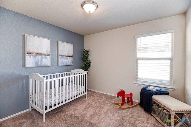 bedroom with carpet and a crib