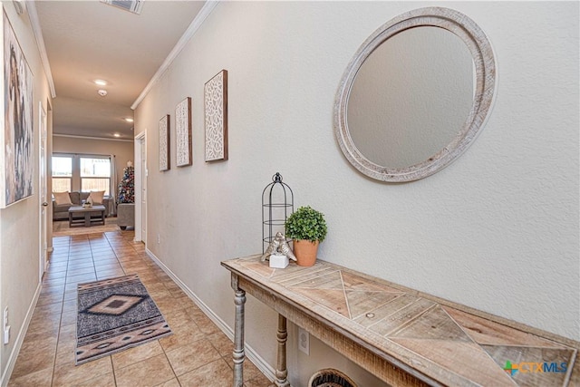 corridor with light tile patterned flooring and ornamental molding