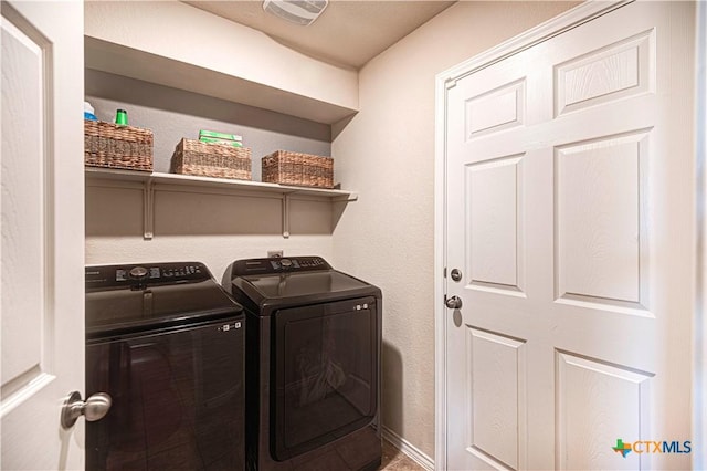 clothes washing area with washing machine and clothes dryer