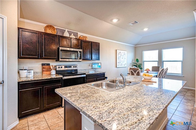 kitchen with dark brown cabinetry, sink, stainless steel appliances, an island with sink, and vaulted ceiling