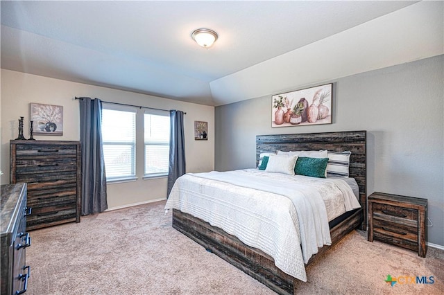 bedroom with light carpet and vaulted ceiling