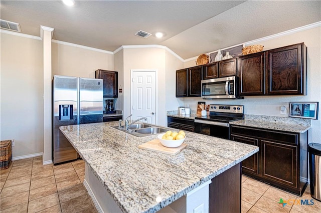 kitchen with appliances with stainless steel finishes, dark brown cabinets, sink, lofted ceiling, and an island with sink