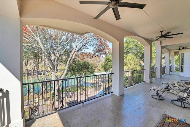 view of patio featuring a balcony and ceiling fan