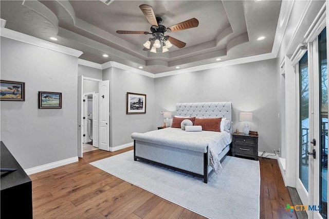 bedroom featuring french doors, ceiling fan, dark hardwood / wood-style flooring, and a raised ceiling