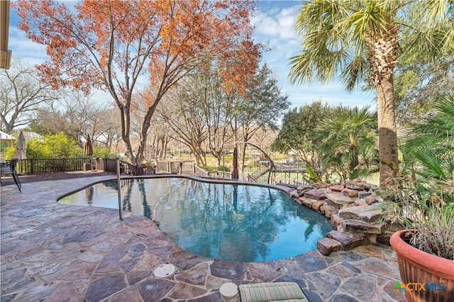 view of swimming pool with a patio