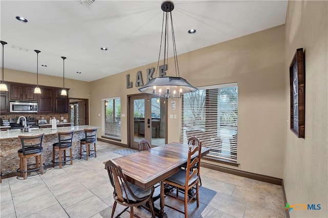 dining area with french doors and sink