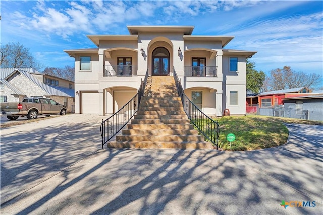 view of front facade featuring a balcony and a garage