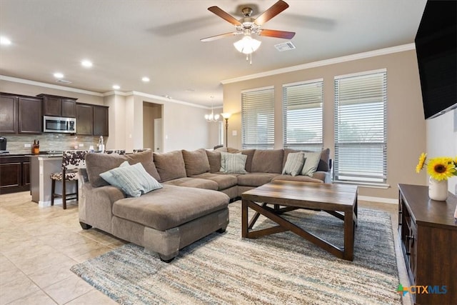 living room with light tile patterned flooring, ornamental molding, and ceiling fan with notable chandelier