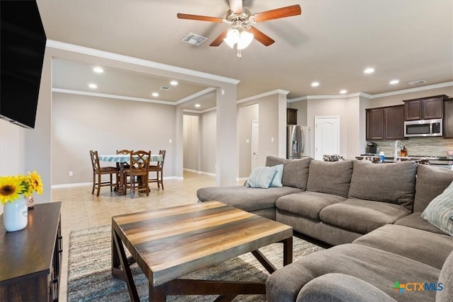 living room with crown molding, ceiling fan, and light tile patterned flooring