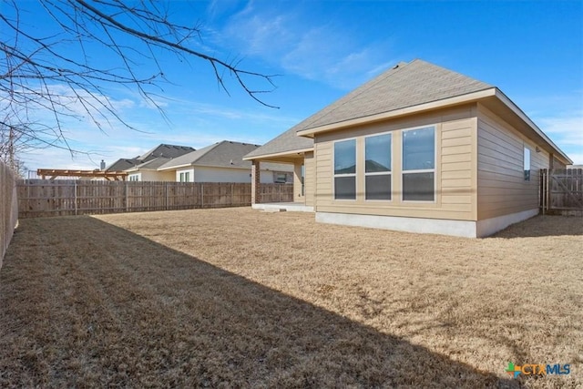 rear view of property with a yard