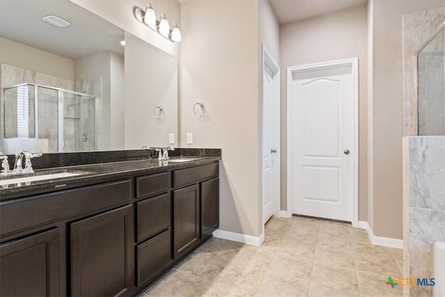 bathroom with tile patterned floors, vanity, and a shower with shower door