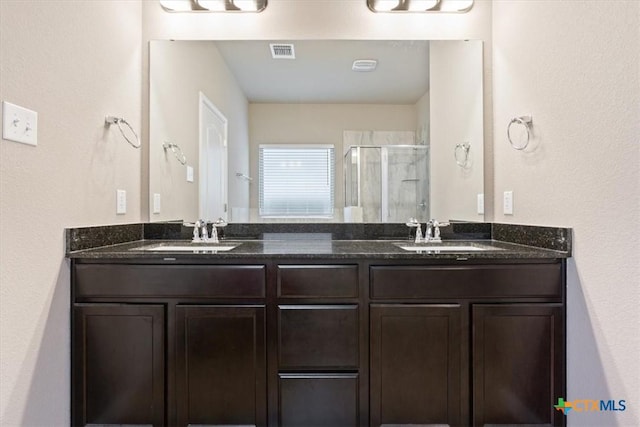 bathroom featuring an enclosed shower and vanity