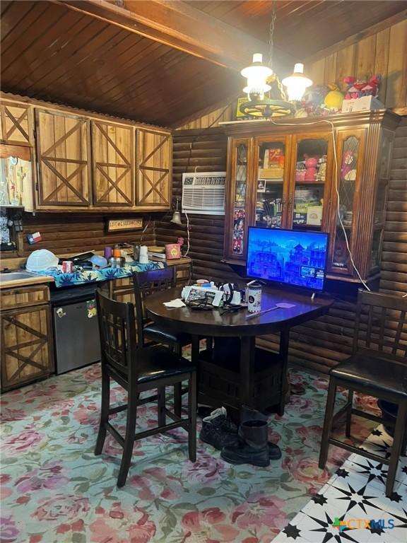 304 Kegley St, Belton, TX 76513 - dining room with a notable chandelier, an AC wall unit, wooden ceiling, and rustic walls