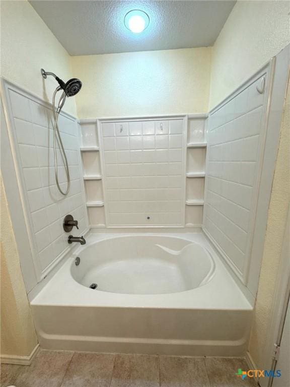 bathroom featuring tile patterned flooring, tub / shower combination, and a textured ceiling