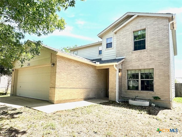 201 Windridge Dr, Lockhart, TX 78644 - traditional-style house featuring brick siding and an attached garage