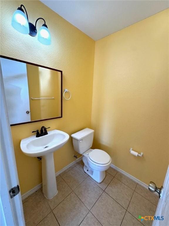 201 Windridge Dr, Lockhart, TX 78644 - half bathroom with tile patterned flooring, toilet, and baseboards