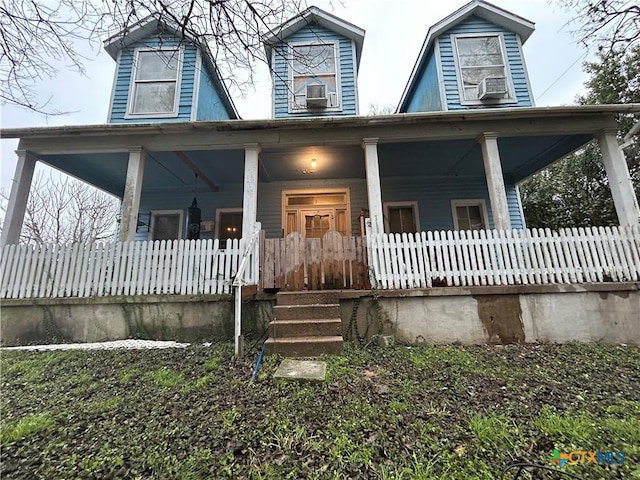 new england style home featuring covered porch and cooling unit