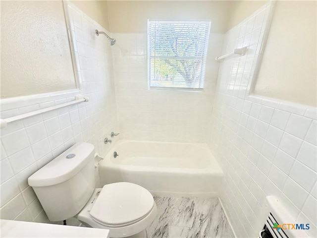 909 S 23rd St, Copperas Cove, TX 76522 - full bathroom featuring tile walls, tub / shower combination, toilet, and a wainscoted wall