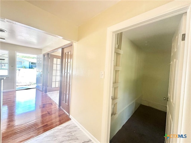 909 S 23rd St, Copperas Cove, TX 76522 - hall with baseboards, marble look tile flooring, and french doors