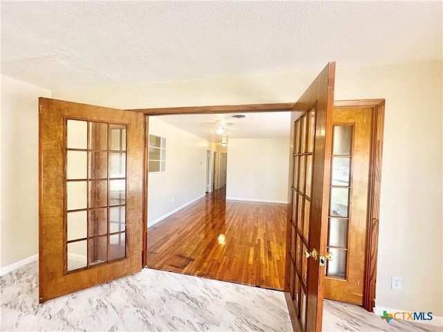 909 S 23rd St, Copperas Cove, TX 76522 - spare room featuring french doors, baseboards, a textured ceiling, and a ceiling fan