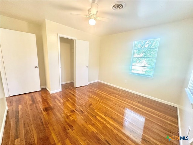 909 S 23rd St, Copperas Cove, TX 76522 - unfurnished bedroom featuring wood-type flooring, baseboards, and a ceiling fan