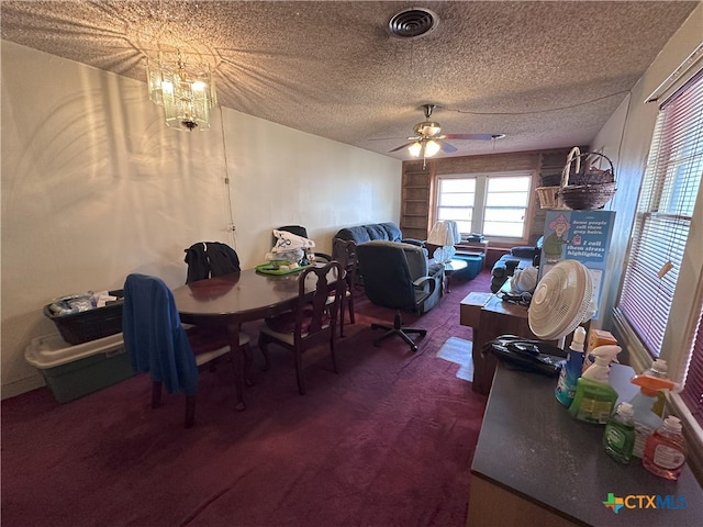 office with ceiling fan with notable chandelier, a textured ceiling, and carpet floors