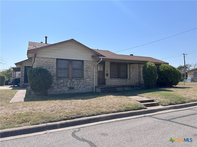 ranch-style home with a front lawn