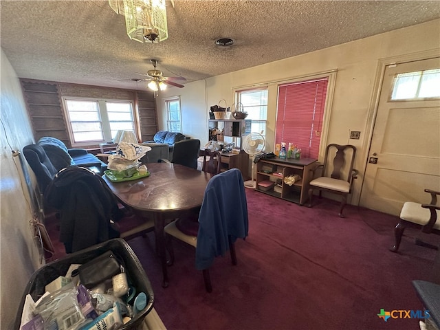 carpeted dining room with a textured ceiling and ceiling fan