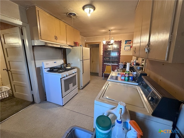 kitchen with hanging light fixtures, white appliances, light brown cabinetry, and washer / clothes dryer