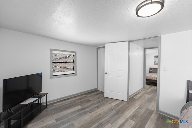 interior space featuring hardwood / wood-style floors and a textured ceiling