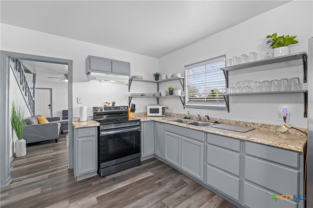 kitchen with dark wood-type flooring, gray cabinetry, sink, and electric range